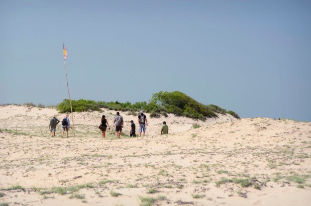 Law Boss, Phillip Roe leads an anthopologist, marine biologist and protectors through the Dunes at Walmadan.